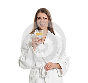 Young woman with glass of lemon water on white