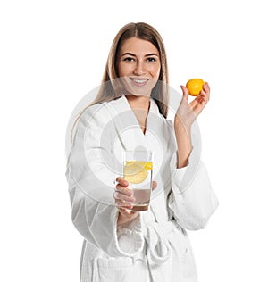 Young woman with glass of lemon water on white