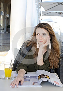 Young woman with glass of orange juice outdoors