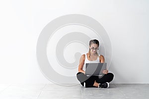 Young woman in glasses casual & comfotable using laptop.