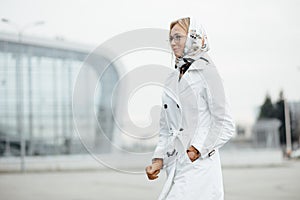 Photo of fashionable girl with beautiful brown hair smiling to c