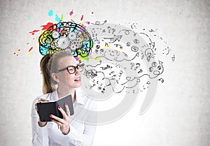 Young woman in glasses writing, brain and arrows