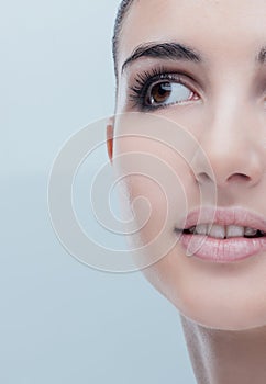 Young woman with glowing face skin