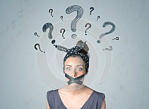 Young woman with glued mouth and question mark symbols