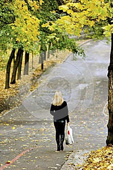 Young woman go with bags