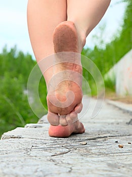 A young woman goes barefoot