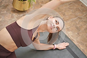 Young woman going yoga exercise at home. Health care online lessons