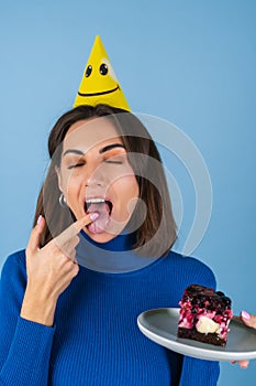 Young woman in golf on a blue background celebrates a birthday