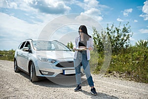 Young woman got lost and looking to a map for planning new trip