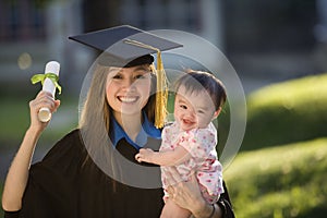 Young woman graduate holding baby