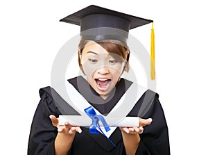 Young woman graduating holding diploma and looking