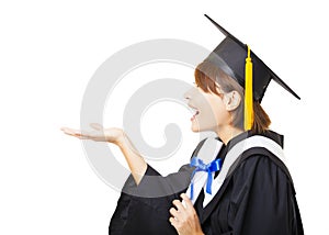 Young woman graduating holding diploma and looking