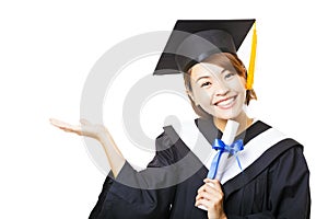 young woman graduating holding diploma and showing gesture