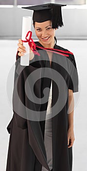 Young woman Graduating holding her Diploma