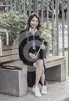 Young woman with graduation gown after graduation