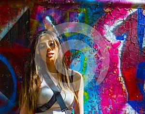 Young woman with graffiti on wall, sexy fashion young woman with graffiti