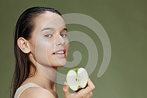 young woman green apple near face health close-up Lifestyle