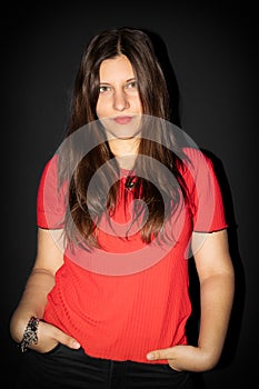 Young woman, green eyes, white skin, red clothes, black background.