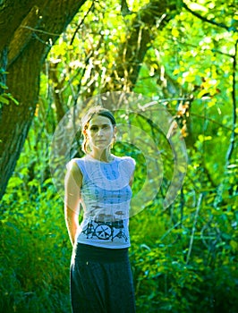 Young woman in green forest