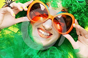 Young woman with green hair and carnaval glasses photo