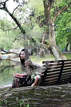 Young woman in green park, book and reading. Happiness, beautiful