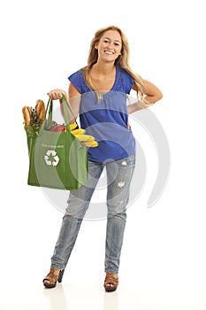 Young woman with green recycled grocery bag