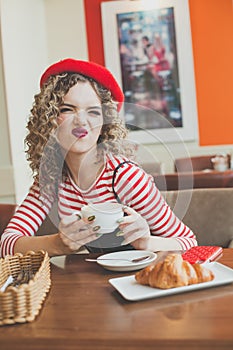 Young woman grimacing in cafe
