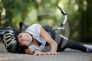 young woman on ground after bicycle accident