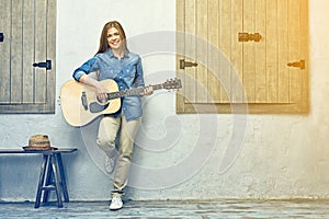 Young woman guitar playing on street.