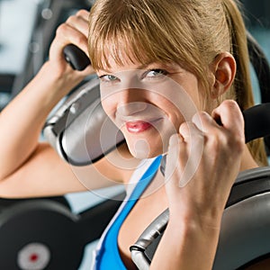 Young woman at gym exercise fitness