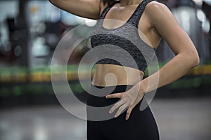 Young  woman in a gym  exercises