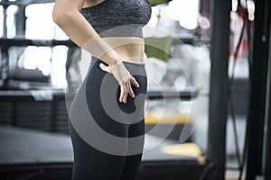 Young  woman in a gym  exercises