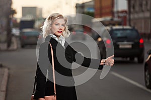 Young woman hailing a taxi cab