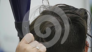 Young woman in a hair salon getting her hair blow dried