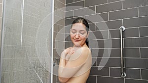 Young woman hair stands under shower
