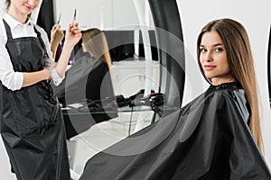 Young woman with hair stylist photo