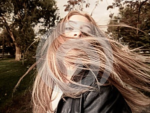 Young woman with hair swept by wind