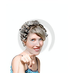 Young woman with haircurlers in her heir photo