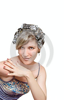Young woman with haircurlers in her heir photo
