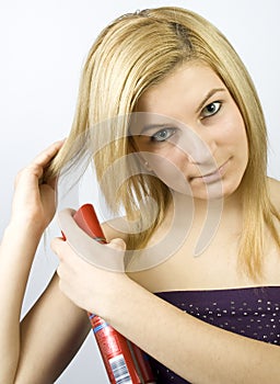 Young woman with hairspray photo
