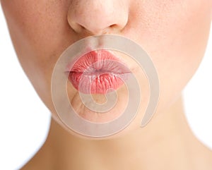 Young woman half face kissing lips