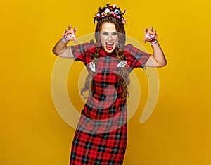 Young woman in halloween costume frightening