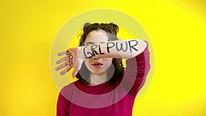 Young woman with hand and arm written covering her eyes and claiming women's rights and equality.