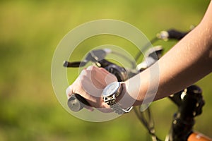 Young woman hand on bike handle