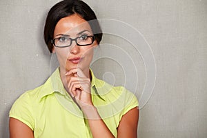 Young woman with hand on chin and contemplating