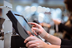 Young woman hand doing process payment on a touchscreen cash register, POS, finance concept photo