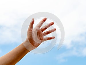 Young woman hand. Empty hand reach out or hold over blue sky. Help and hope hand concept