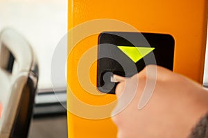 Young woman hand inserts the bus ticket into the validator, validating and ticking in Prague sity Chezh