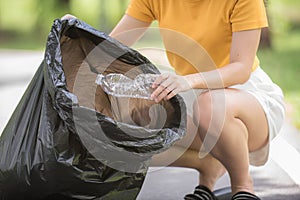 Young woman hand picking up garbage plastic