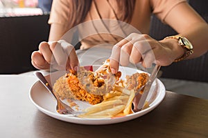 in young woman hand select focus, Hand with fried chicken blur background, Close-up Fried chicken